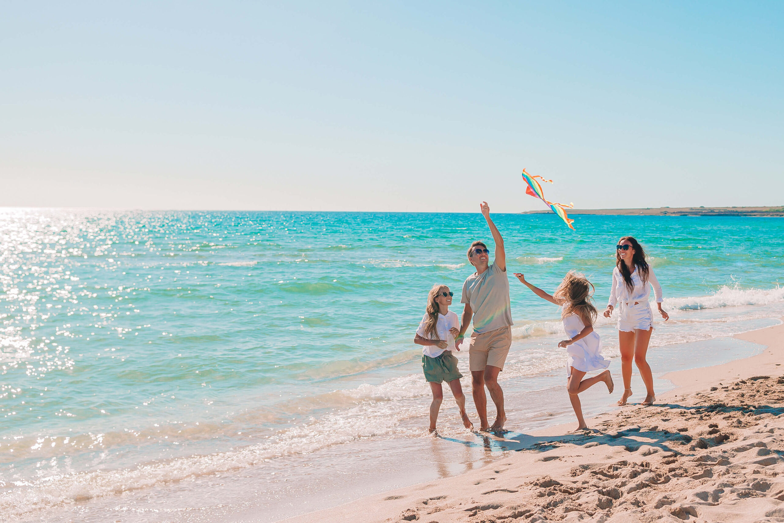 Family running on the beach